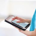 Medical professional holding a tablet computer.